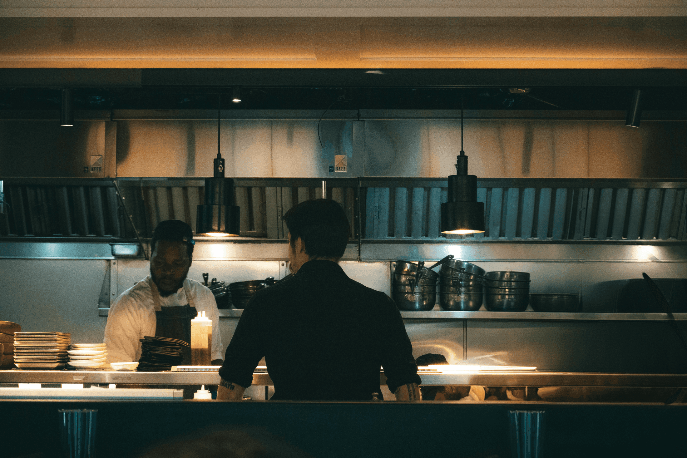 Busy restaurant team serving guests while Chatley AI answers the phone